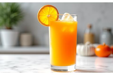 Freshly squeezed orange juice in a glass with orange slices.